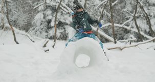 Child plays on giant snowball carved, enjoy winter in nature - Powered by Shutterstock - Get 15% off with code: PIKWIZARD15
