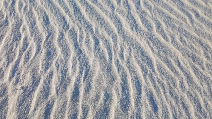 Warm golden light illuminates white gypsum dunes at sunset in White Sands National Park New Mexico