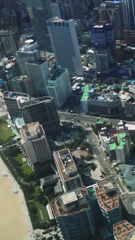 Haeundae beach, Busan, South Korea, aerial view with Busan bay, Songnim Park, Haeundae-gu district, white sand beach promenade, sea with Dongbaekseom Island, Gwangan bridge and Busan skyline panorama