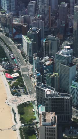 Haeundae beach, Busan, South Korea, aerial view with Busan bay, Songnim Park, Haeundae-gu district, white sand beach promenade, sea with Dongbaekseom Island, Gwangan bridge and Busan skyline panorama