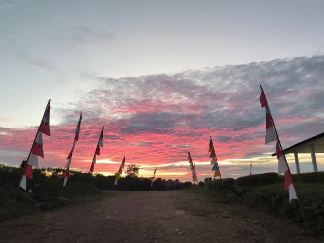 Evening sky with flags creating a ceremonial pathway silhouette