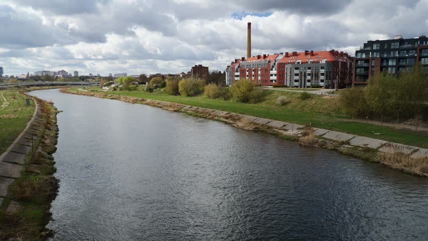 The Varta River, next to a new neighborhood built on its bank. Poznan, Poland.