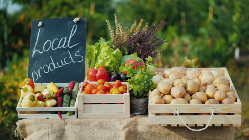 Local vegetables and potatoes on a market table, farm stand bounty.