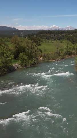 River mountain landscape. Mountain river, trees, sky. Landscape with a flowing river. Flight over the river, fast current. High quality 4k footage