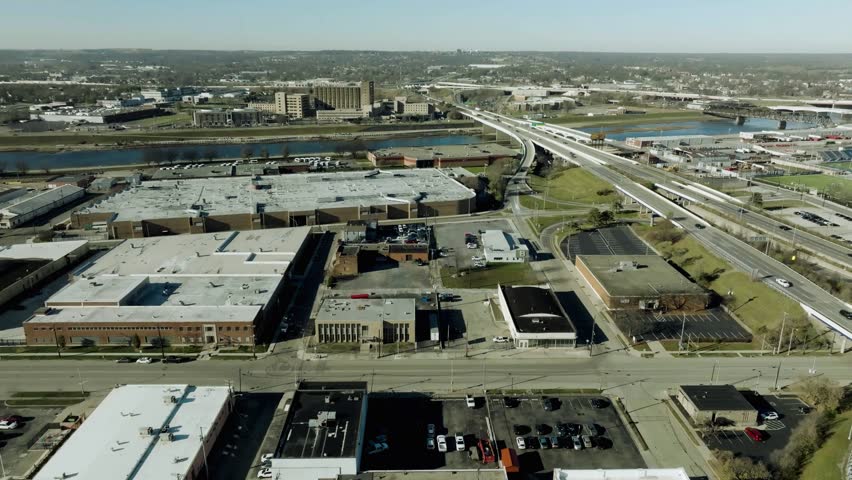 Aerial pan left to right over Dayton, showcasing transportation routes, highways and urban skyline, smooth flyover motion, cinematic cityscape, high resolution 4K drone travel footage.