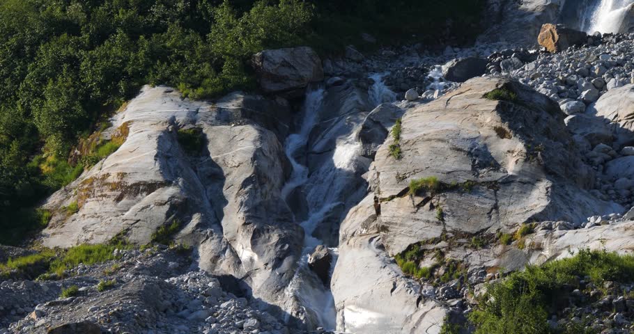 Spectacular Waterfall along the granite steep wall of the mountain at Endicott Arm Fjord, Alaska.