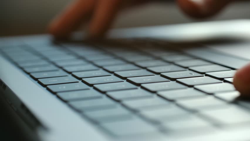 Detailed close up human fingers typing on modern laptop computer keyboard, representing remote work, online communication, freelancing, digital business tasks. Person hands typing on laptop keyboard
