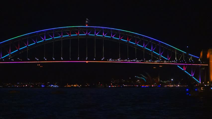 close up shot of the sydney harbour bridge illuminated with colorful lights for the Vivid Sydney Festival 2013
