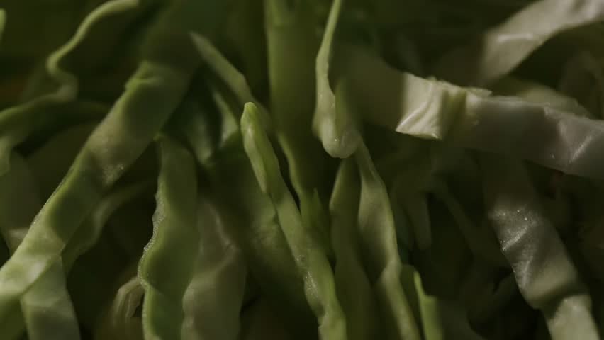 Cabbage salad close-up, fresh cabbage chopped in the kitchen, healthy food, dark appearance