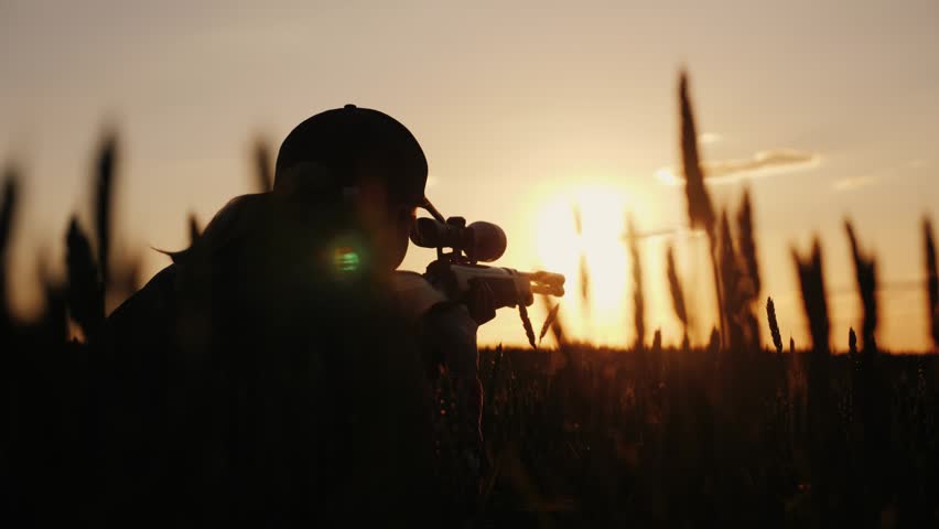 Female hunter targeting rifle, golden hour motion, outdoor sport.