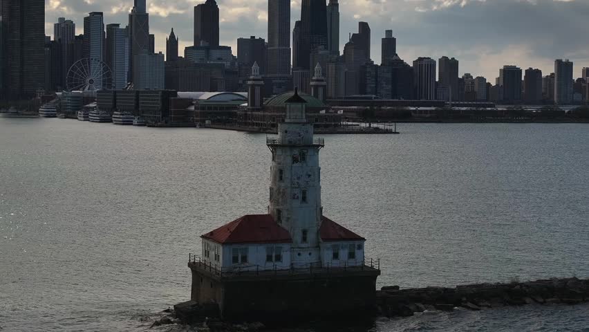 Drone view of the Chicago lighthouse with the city of Chicago in the background.