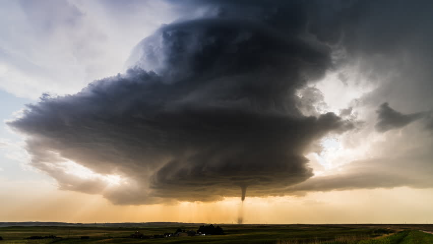 A powerful tornado rotates beneath towering supercell clouds, creating an intense severe weather scene with violent winds, dark atmospheric conditions, turbulent skies and dramatic storm chasing energy across the landscape