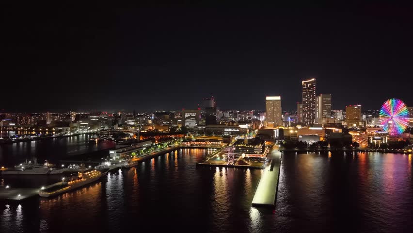 Aerial night view of the historic Yokohama Red Brick Warehouse district and illuminated waterfront in Yokohama, Japan.

