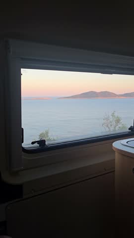 Enjoy breathtaking sunset vistas over the tranquil sea in Kas, Turkey. camping in a camper van or motorhome at the seaside on a cliff