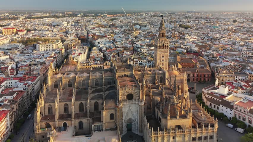 Stunning aerial view of majestic Seville Cathedral during golden hour, Seville, Spain. Giralda tower stands tall over the historic city landscape of Andalusia 