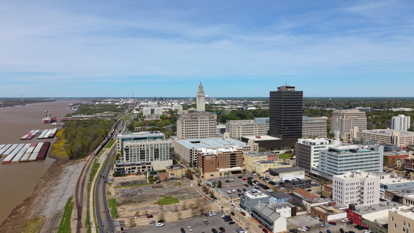 Louisiana State Capitol rising above Baton Rouge skyline. Scenic aerial view of government district and urban development in the USA.