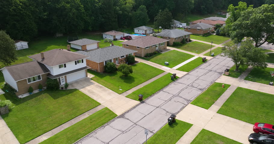 Low-density two story private homes with large lot size and green grassy lawns in summer season. Rural residential suburbs with upscale suburban houses outside of Cleveland, Ohio.