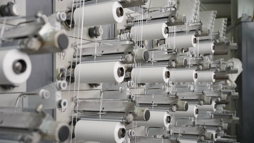 Polypropylene threads winding on industrial weaving loom machine