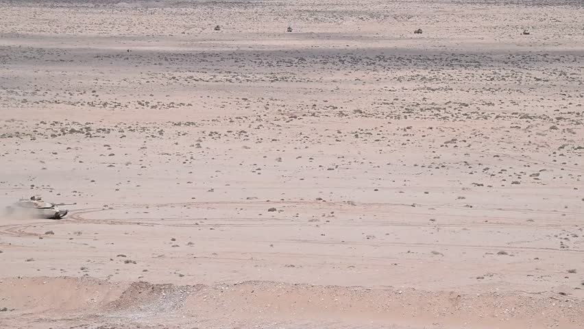 Abrams tanks and other main battle tanks in action in the vast desert.