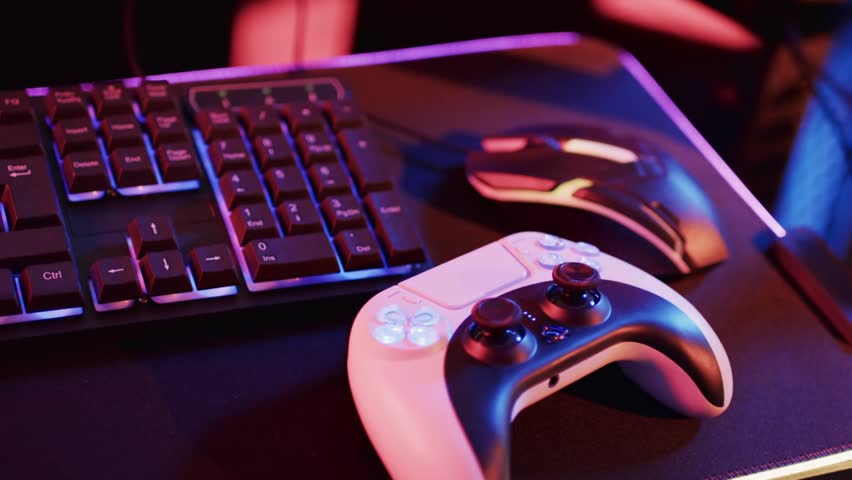 RGB pulse hitting white-black gamepad, emitting shapes floating, clustering to highlight buttons. Controller, peripherals, desk, gaming, neon, magenta, blue