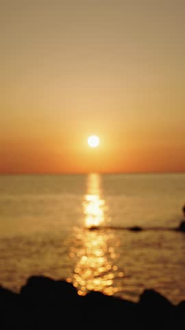 Couple holding hands sunset ocean water reflection romance.