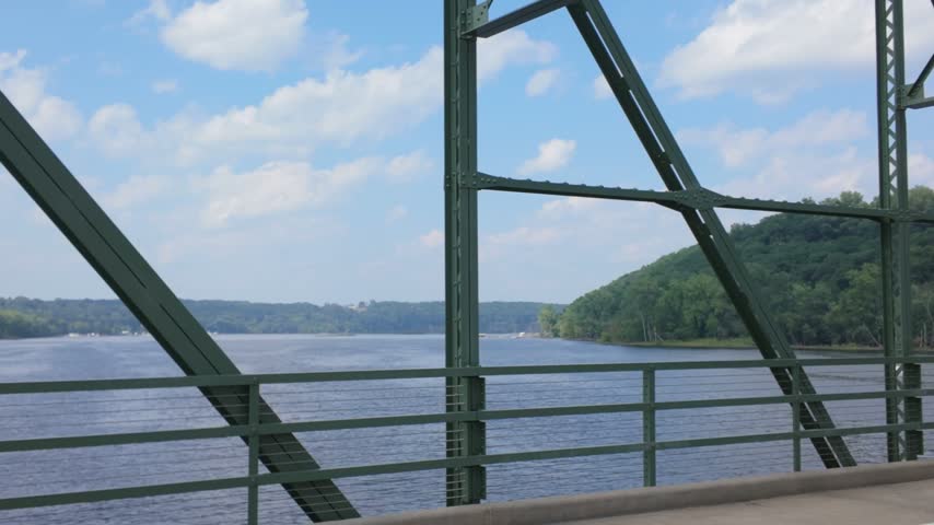 Gimbal wide panning shot of the St. Croix River from the lift bridge connecting Stillwater, Minnesota to Houlton, Wisconsin. 4K