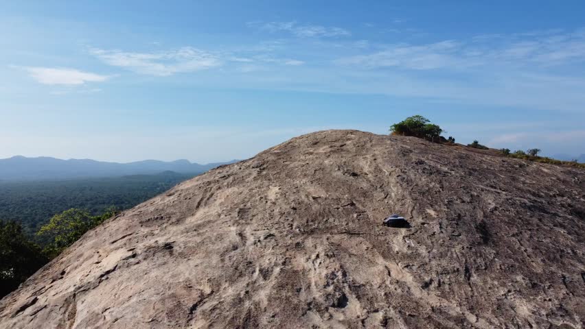 Drone footage of Sigiriya Lion Rock in Sri Lanka with breathtaking views of lush landscapes and ancient surroundings.