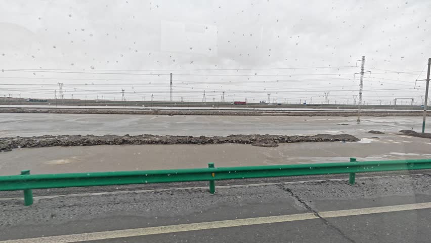 
looking out the bus glass window while traveling through the steppe landscape scene. 