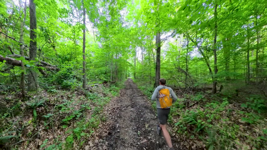 Following Man Running on Muddy Trail in Mammoth Cave National Park