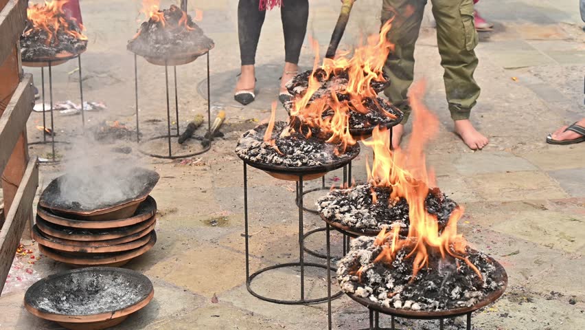 Nepali people burning somethings for making a worship to their god in Kathmandu Durbar Square, Nepal. These ceremonies using fire to connect with the divine and guide spirits to the afterlife.