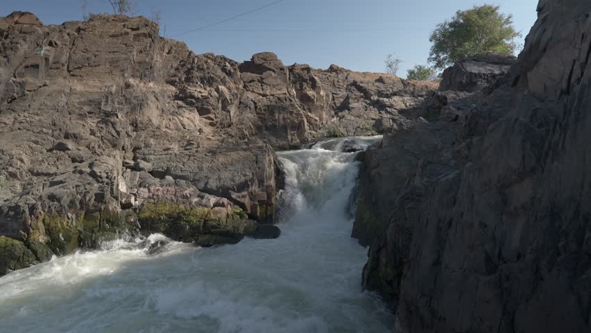 A turbulent section of water with washback and water flowing from all directions in a rapids section of Li Phi Somphamit falls in Laos.