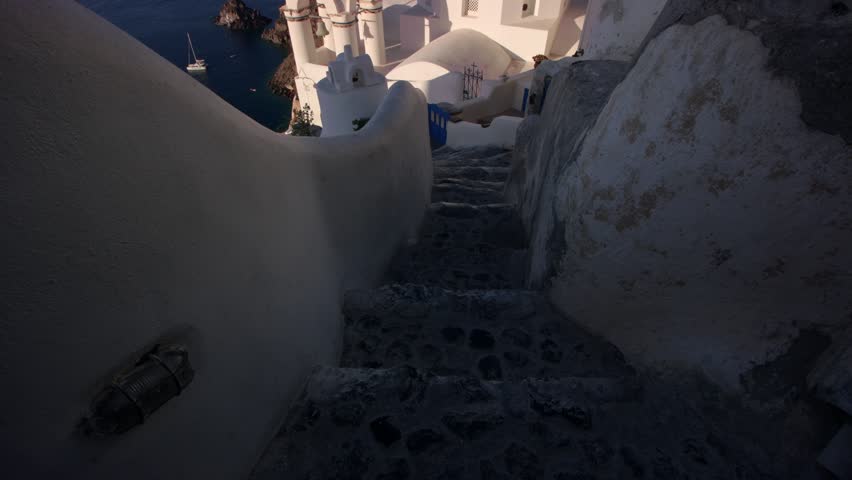 This 4K video shows the Church of Agios Spyridonas and the Church of Anastaseos in Oia, Santorini. The visual documents the blue-domed roofs and white-washed masonry characteristic of Cycladic architecture. The composition illustrates the settlement’s position on volcanic cliffs overlooking the Aegean Sea caldera, documenting Greek ecclesiastical infrastructure and Mediterranean geography for editorial and geographic media.