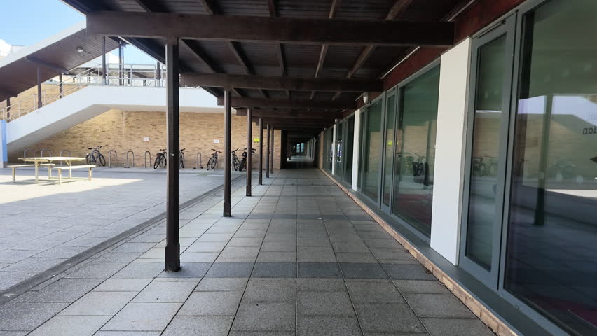 Walking down covered walkway at university campus