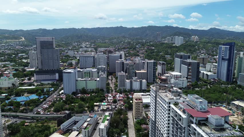 Drone flight above Cebu City center showing urban development, architecture in the Philippines.