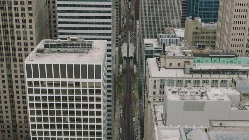 A detailed aerial view of contemporary glass skyscrapers and high-rise buildings in the central business district.