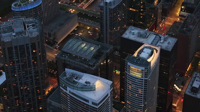 Aerial view of diverse architectural styles and rooftop terraces in downtown Chicago at dusk.