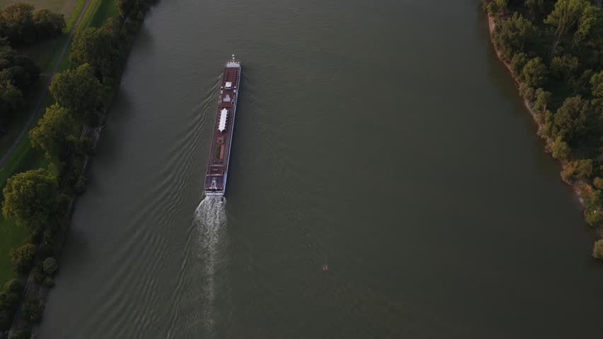 Aerial view of river cruise ship sailing on a waterway