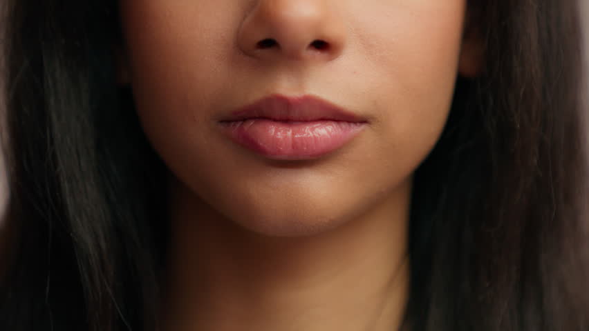 Cropped view close up female mouth sensual lips unrecognizable Hispanic girl unknown woman half face natural moisturize lip balm lipstick perfect skin care beauty filler injection make-up cosmetic