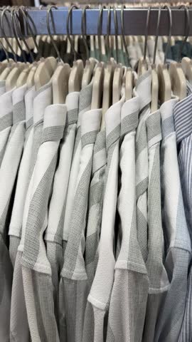Shirts on hangers in clothing store display background showcasing various striped patterns video