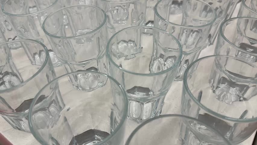 Glass cups arranged in rows creating abstract geometric background video