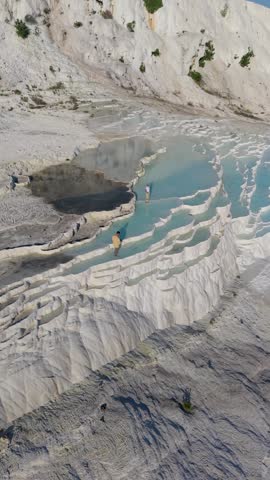 A couple discovers the breathtaking travertine terraces of Pamukkale, Turkey, where thermal waters create beautiful formations.