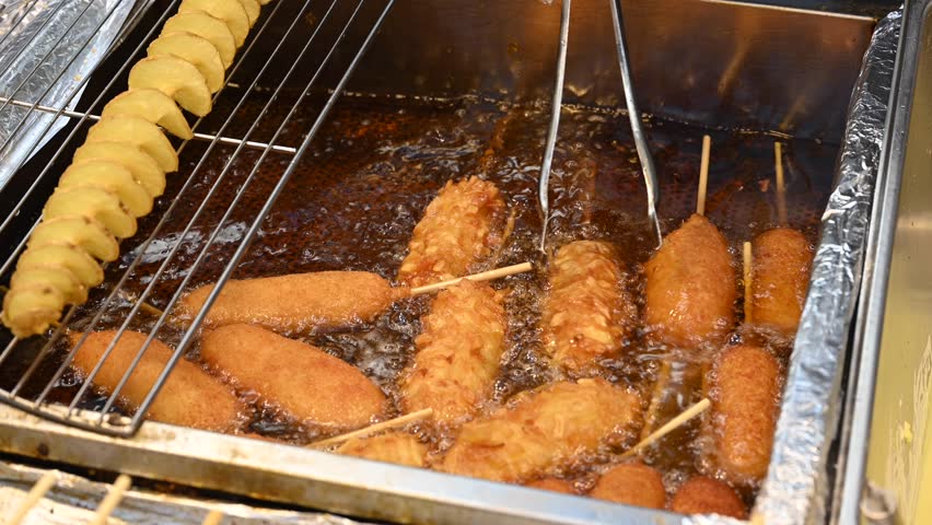 Korean street food preparation at a late-night street stall in Seoul, South Korea.