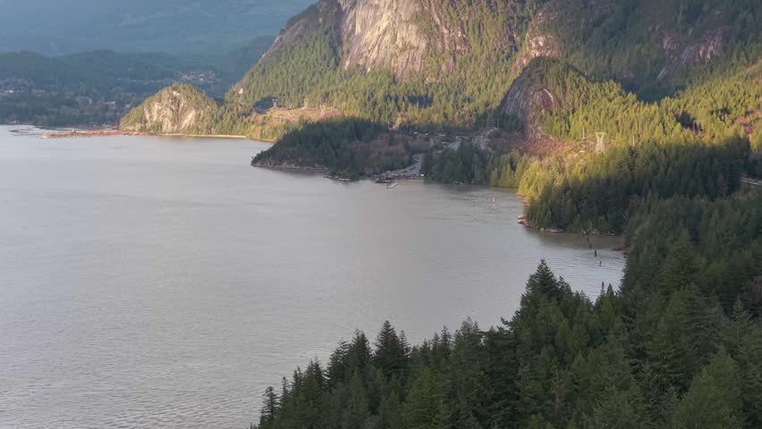 Majestic Mountains and Verdant Forest Surround a Serene Bay in British Columbia, Canada