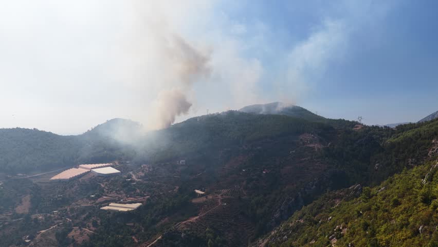 Aerial Video Wildfire in Dry Forest Area with Rapid Spread Fire moving quickly across dry landscape, fueled by vegetation and terrain conditions