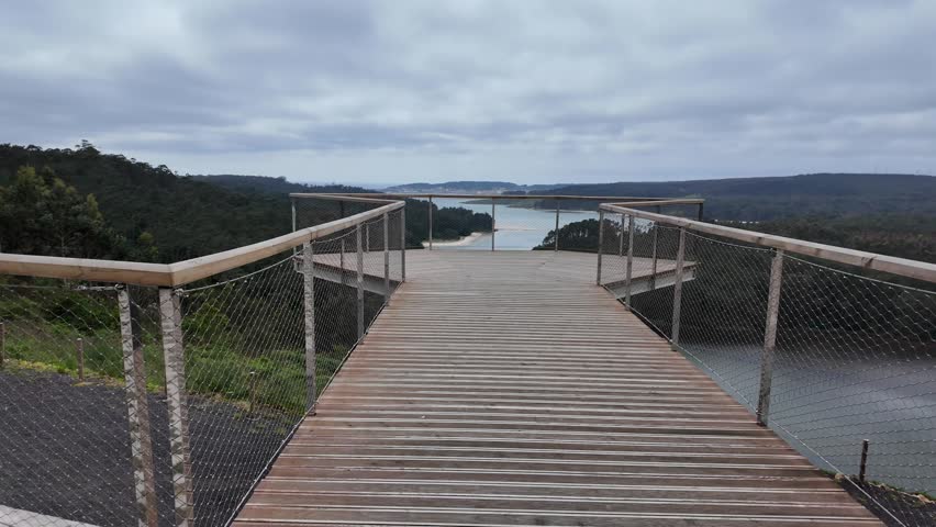 Furna do sapo viewpoint overlooking a winding river estuary surrounded by green forests under an overcast sky