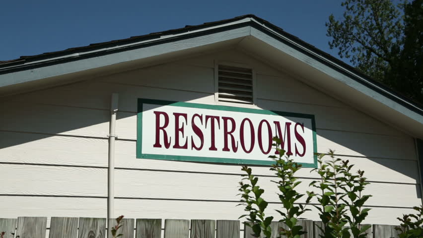 Restrooms sign on bathroom building in Old Town Spring.