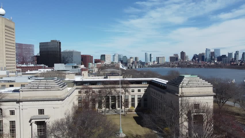 Cinematic drone footage circling the iconic facade of MIT in Cambridge, Massachusetts, showcasing the university campus and its monumental architecture.