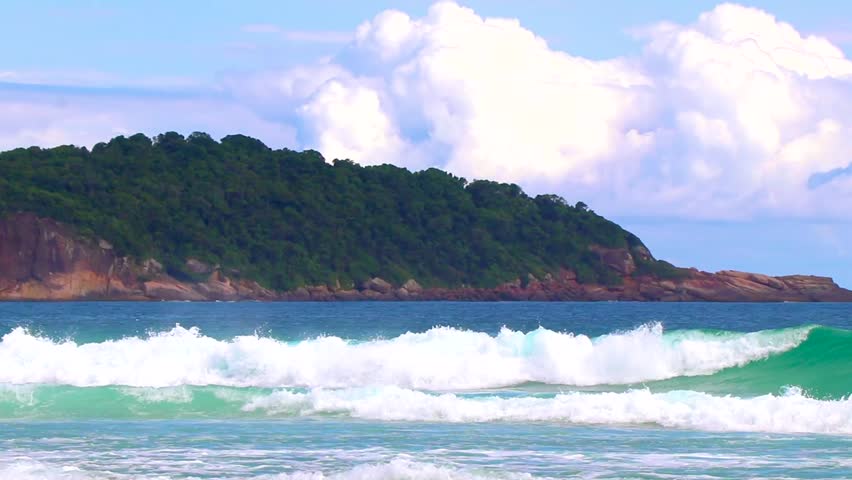 Strong waves at amazing Praia de Lopes Mendes beach on the big tropical island Ilha Grande seascape panorama ocean turquoise water blue sky in Angra dos Reis Rio de Janeiro Brazil.