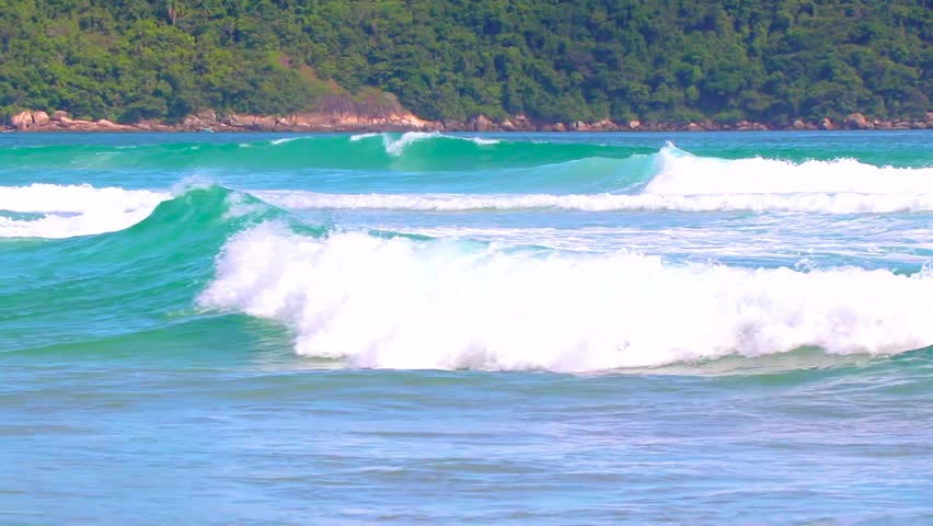 Strong waves at amazing Praia de Lopes Mendes beach on the big tropical island Ilha Grande seascape panorama ocean turquoise water blue sky in Angra dos Reis Rio de Janeiro Brazil.