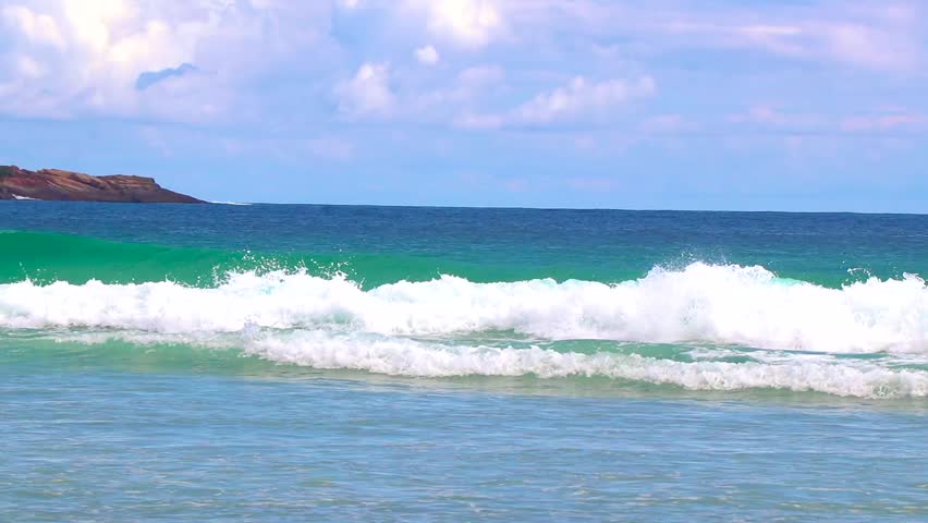 Strong waves at amazing Praia de Lopes Mendes beach on the big tropical island Ilha Grande seascape panorama ocean turquoise water blue sky in Angra dos Reis Rio de Janeiro Brazil.